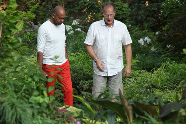Bob, right, shows a visitor the garden