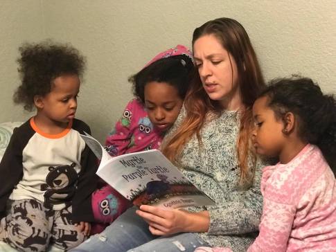 Blog Photo - Myrtle being read to children by Ashly